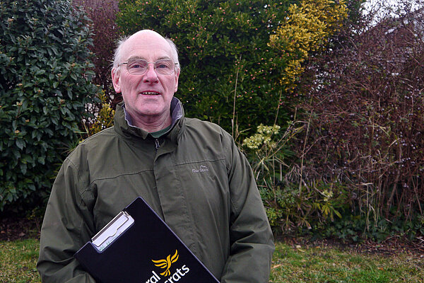Michael Lind standing with a black Lib Dem clipboard