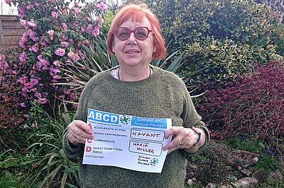 Maria Miller holding her Climate & Nature pledge