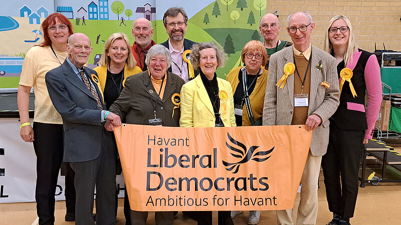 Members of the Havant Lib Dem holding the Havant Lib Dem banner