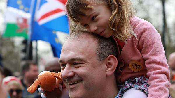 Ed Davey with a child on his shoulders